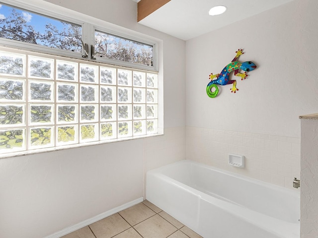 bathroom with tile patterned flooring and a bathing tub