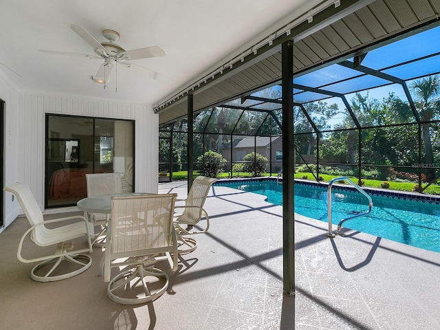 view of pool featuring ceiling fan, a lanai, and a patio area