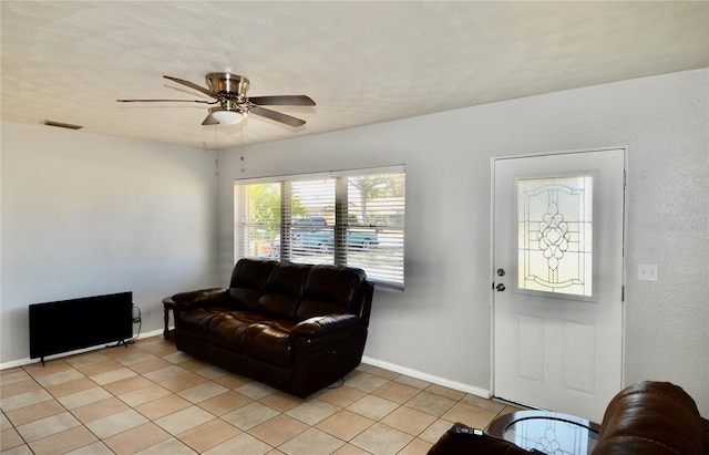 living room with light tile patterned flooring and ceiling fan