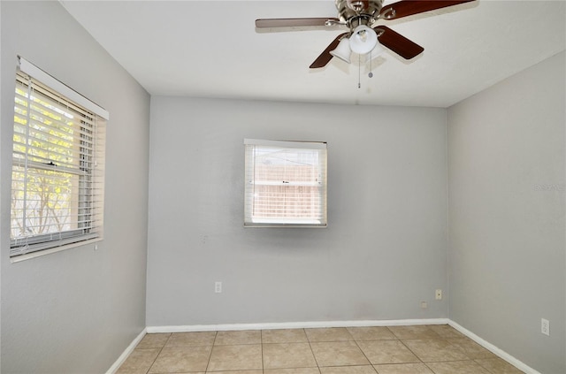 spare room with light tile patterned floors and ceiling fan