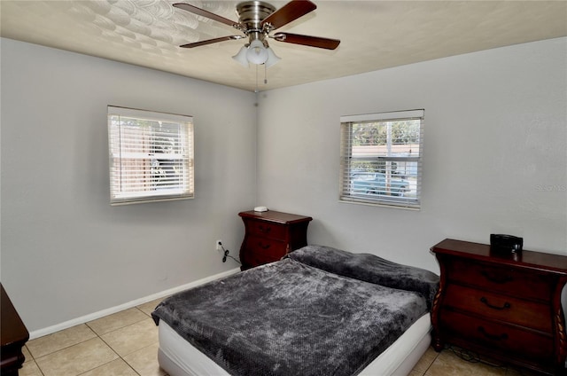 tiled bedroom featuring ceiling fan