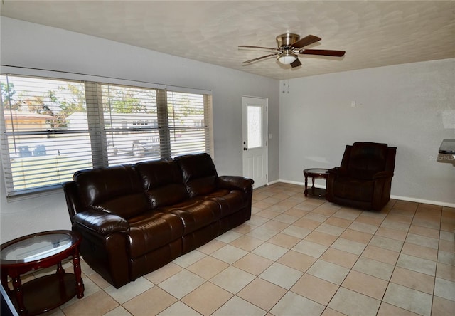 tiled living room with ceiling fan