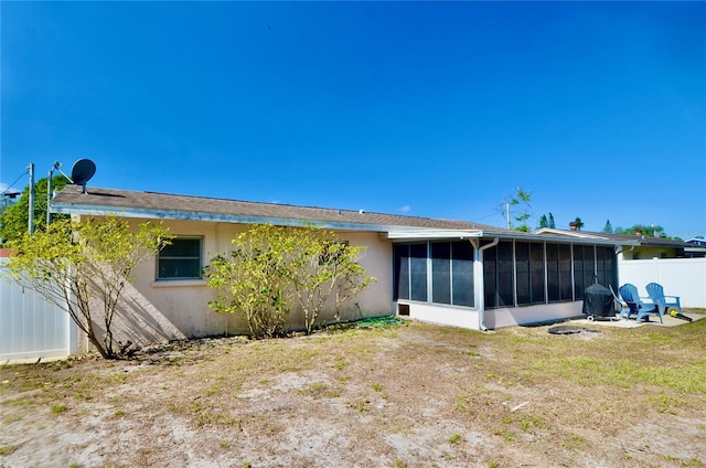 rear view of property with a sunroom