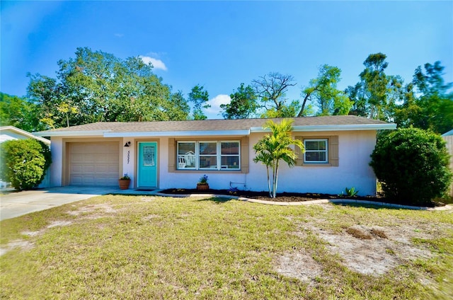 ranch-style home with a garage and a front yard