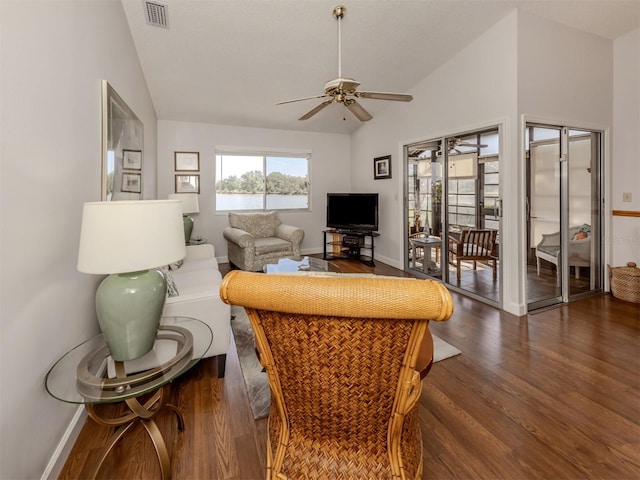 living room with lofted ceiling, dark hardwood / wood-style flooring, and ceiling fan