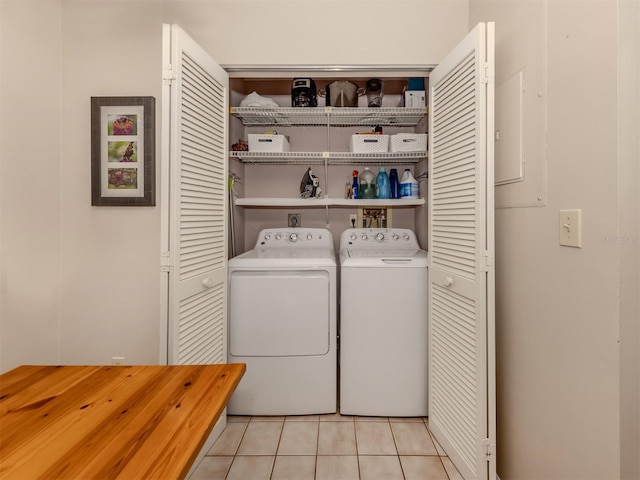 clothes washing area with separate washer and dryer and light tile patterned floors