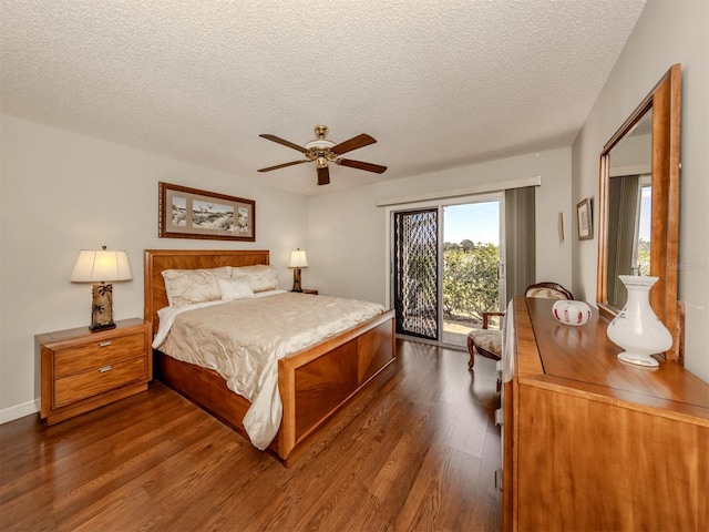 bedroom featuring access to exterior, dark wood-type flooring, a textured ceiling, and ceiling fan