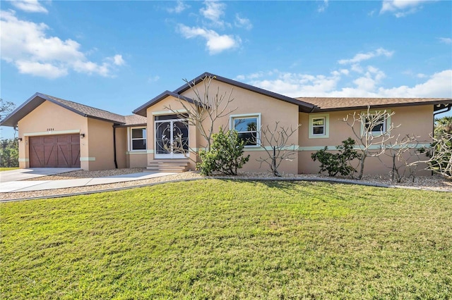 ranch-style house featuring a garage and a front lawn