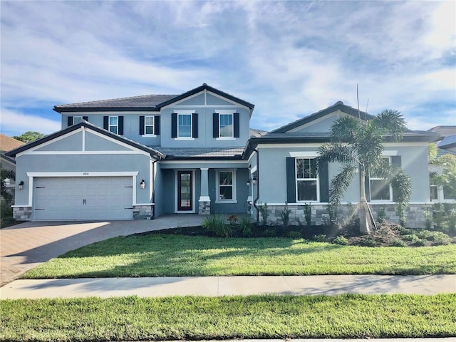 view of front of house featuring a garage and a front yard