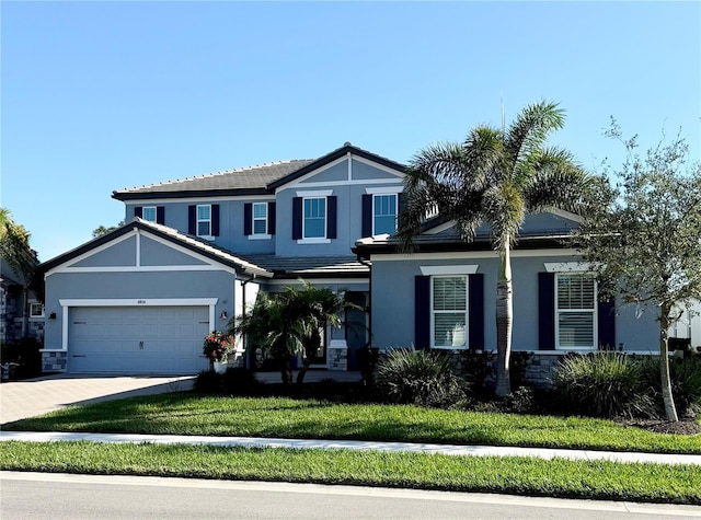 view of front of property featuring a garage and a front yard