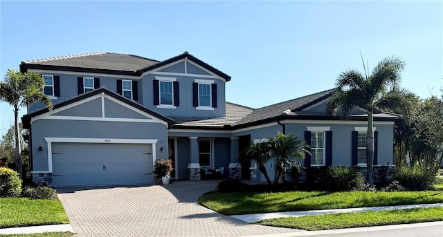 view of front of house with a garage and a front yard