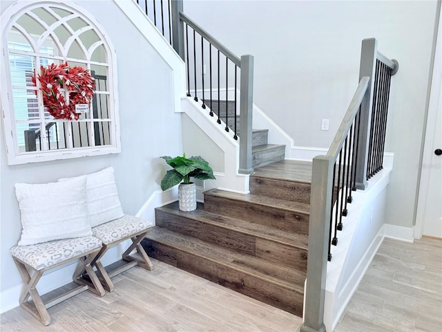 stairs with hardwood / wood-style flooring