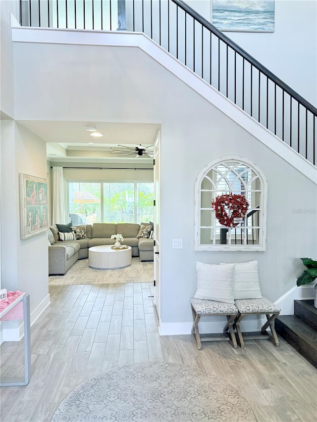 interior space with light hardwood / wood-style floors and a high ceiling