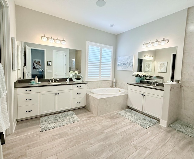 bathroom with vanity, hardwood / wood-style floors, and independent shower and bath