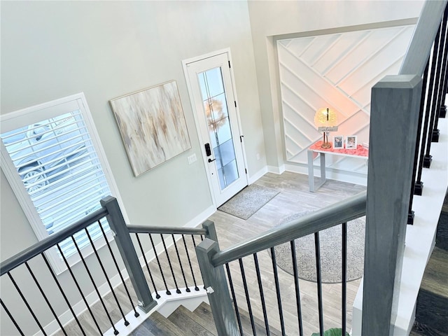 staircase with hardwood / wood-style floors