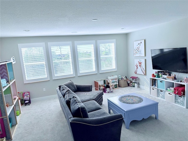 living room featuring light colored carpet and a textured ceiling