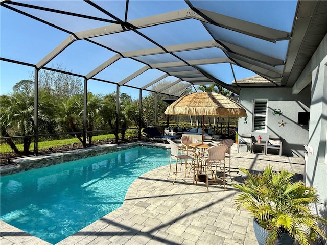 view of swimming pool featuring an outdoor living space, a lanai, and a patio area