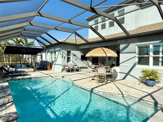 view of swimming pool with a patio area and glass enclosure