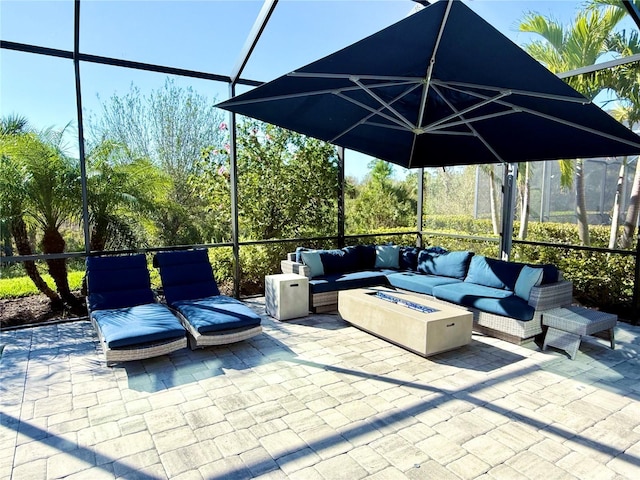 view of patio with an outdoor living space with a fire pit