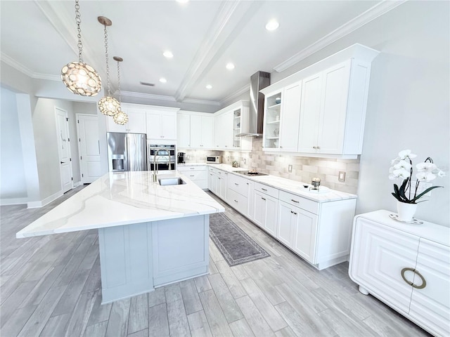 kitchen with light wood-style flooring, a sink, appliances with stainless steel finishes, wall chimney range hood, and backsplash