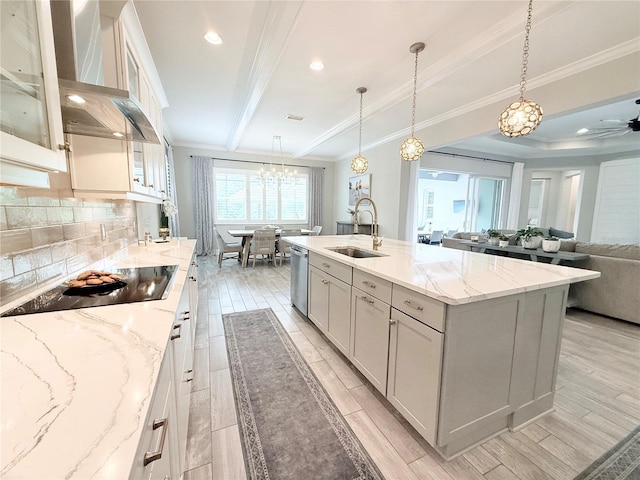 kitchen featuring a sink, black electric cooktop, dishwasher, and crown molding