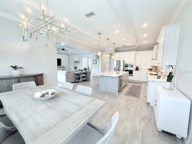 dining area with visible vents, ceiling fan with notable chandelier, recessed lighting, crown molding, and light wood finished floors