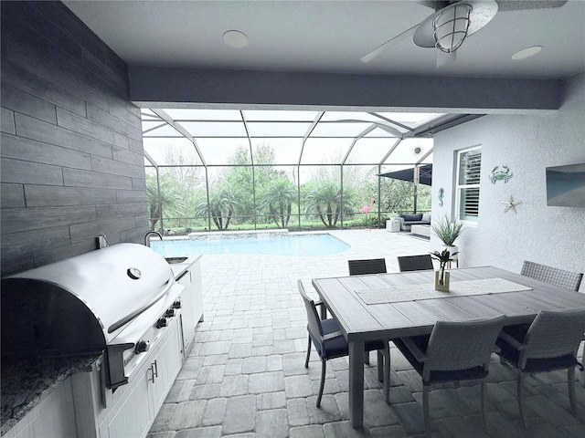 view of patio / terrace featuring an outdoor pool, grilling area, a lanai, and exterior kitchen