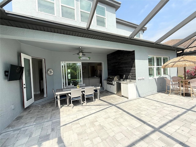 view of patio with a lanai, area for grilling, outdoor dining area, and grilling area