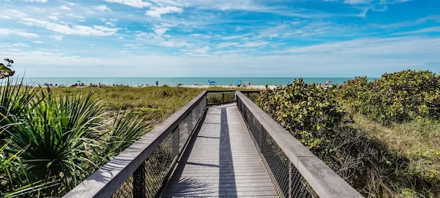 view of home's community with a beach view and a water view