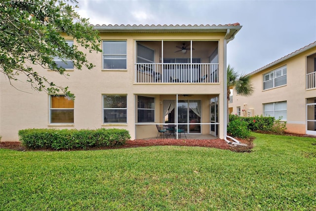 back of property with a lawn, ceiling fan, and a patio area