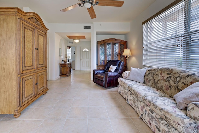 tiled living room with ceiling fan