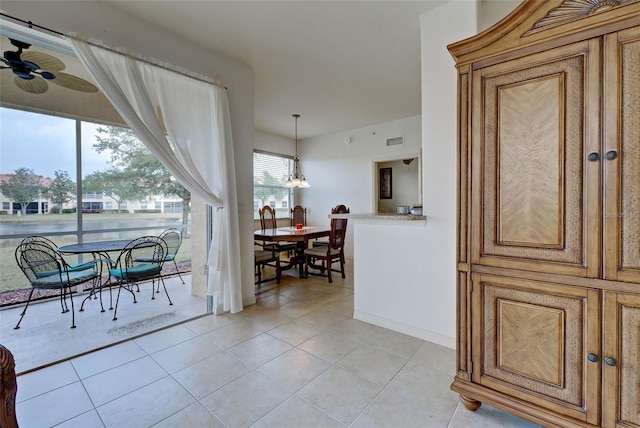 tiled dining room with ceiling fan