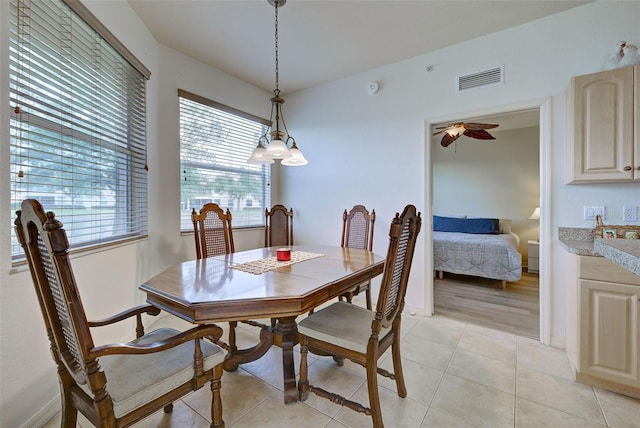 dining space with ceiling fan and light tile patterned floors