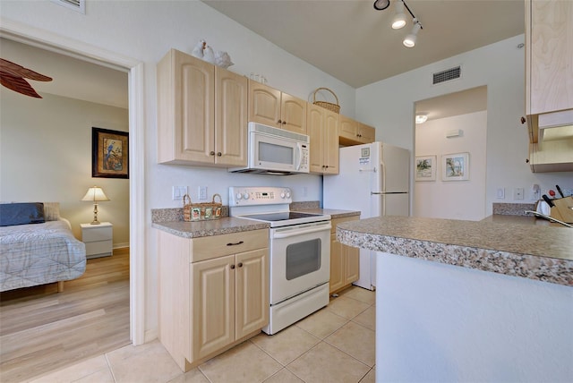 kitchen featuring light tile patterned flooring, white appliances, ceiling fan, and light brown cabinets