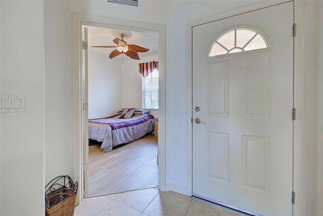 tiled entryway with ceiling fan