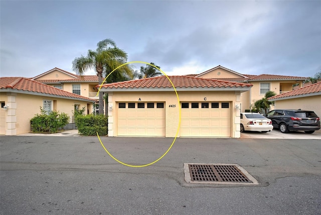 mediterranean / spanish home featuring a garage