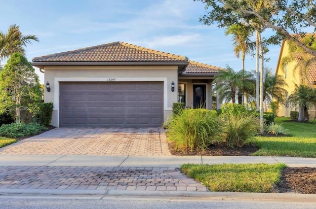 mediterranean / spanish-style house with a garage