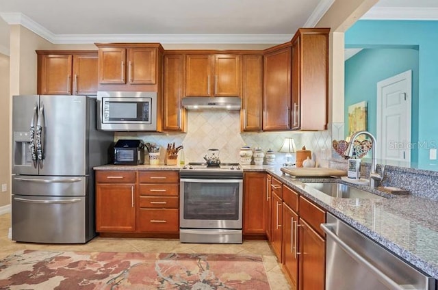 kitchen with tasteful backsplash, sink, ornamental molding, light stone counters, and stainless steel appliances