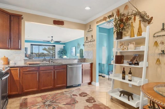 kitchen with ornamental molding, appliances with stainless steel finishes, sink, and stone countertops