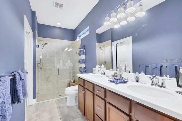 bathroom featuring tile patterned flooring, vanity, toilet, and walk in shower