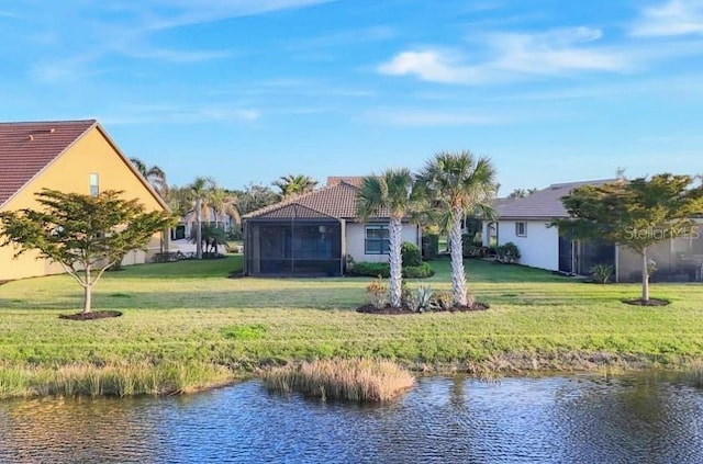 exterior space with a water view and a lawn