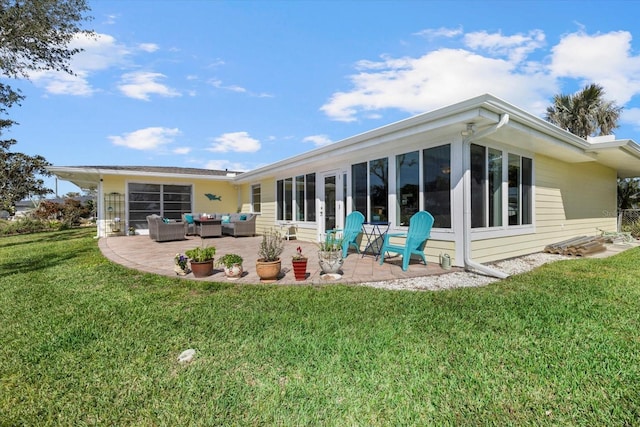 rear view of house featuring a patio, outdoor lounge area, and a lawn