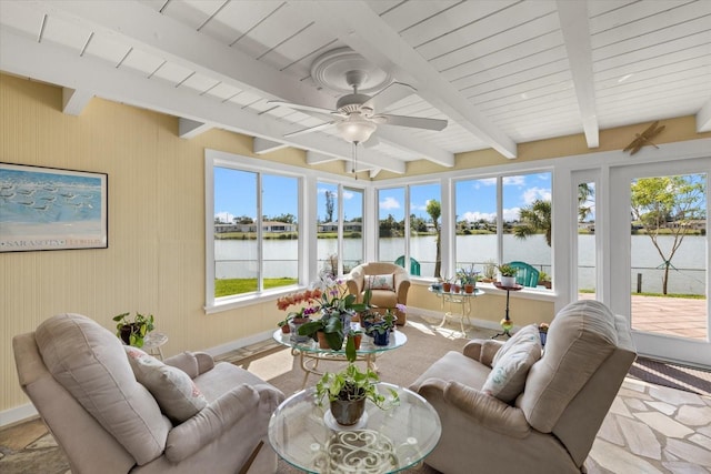 sunroom featuring beamed ceiling, a water view, and ceiling fan