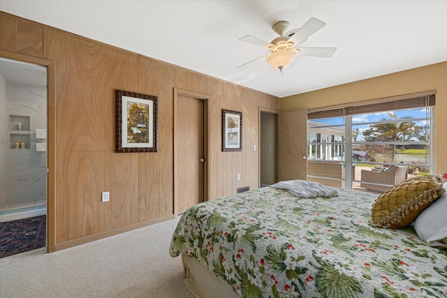 bedroom featuring ceiling fan, wooden walls, and carpet floors