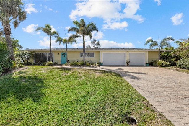 single story home with a garage and a front yard