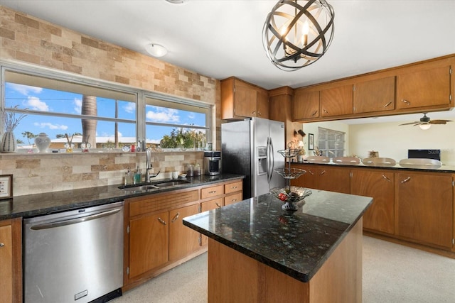 kitchen with sink, decorative light fixtures, a center island, stainless steel appliances, and decorative backsplash