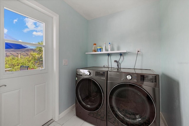 washroom with washer and dryer and light tile patterned floors