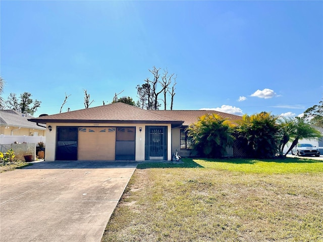 ranch-style house featuring a garage and a front yard