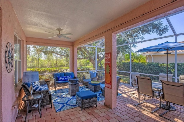 sunroom featuring ceiling fan