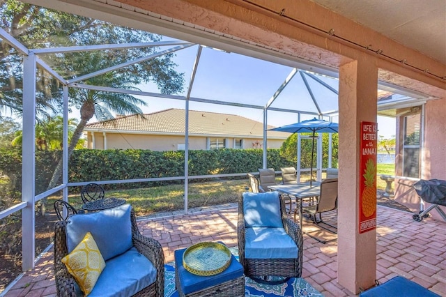 view of patio / terrace featuring glass enclosure